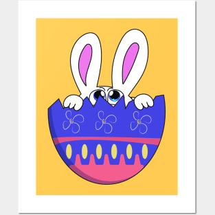 A blue-eyed Easter bunny peeks out of a cracked decorative egg. Posters and Art